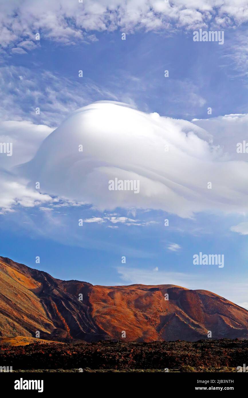 Beautiful hat shape cumulus pileus cloud sky over red mountain - Teide National Park, Tenerife Stock Photo