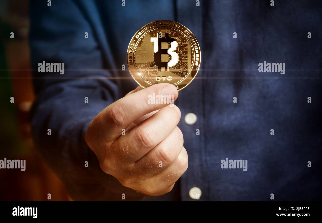 Bitcoin BTC cryptocurrency golden coin in hand abstract concept Stock Photo