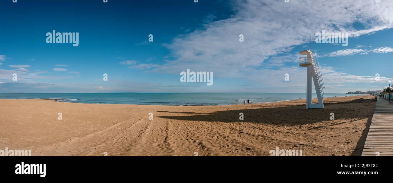 Wide panorama of beach with white lifeguard tower in Torrevieja, off season, Spain Stock Photo
