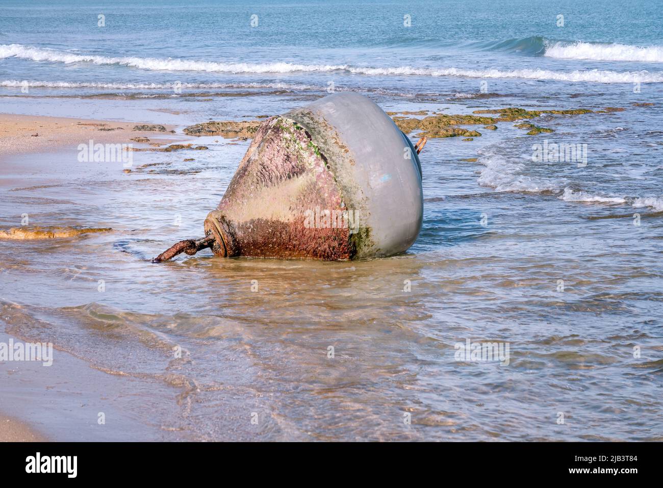 Big floating metal buoy lays on shoreline, side view photo Stock Photo