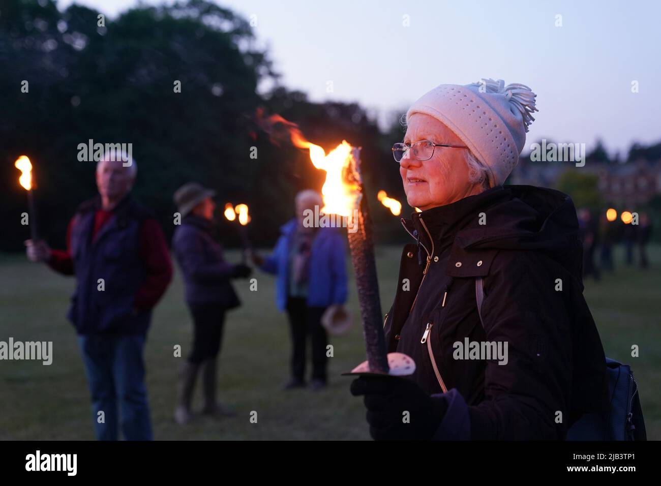 The torchbearers after lighting a Platinum Jubilee beacon on the Queen