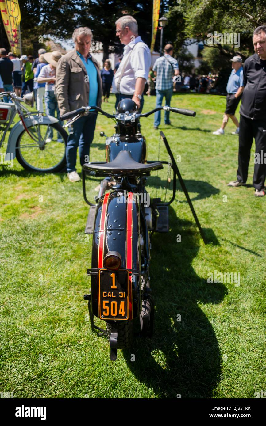 Spectators admire a classic motorcycle in downtown Carmel, seen at the Carmel-by-the-Sea Concours on the Avenue event during Monterey Car Week Stock Photo