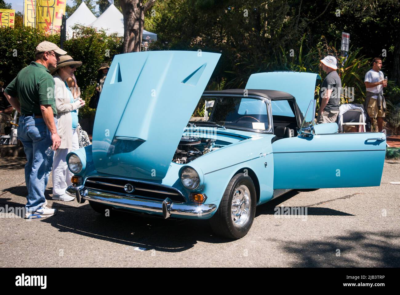 Spectators enjoy classic cars in downtown Carmel, seen at the Carmel-by-the-Sea Concours on the Avenue event during Monterey Car Week Stock Photo