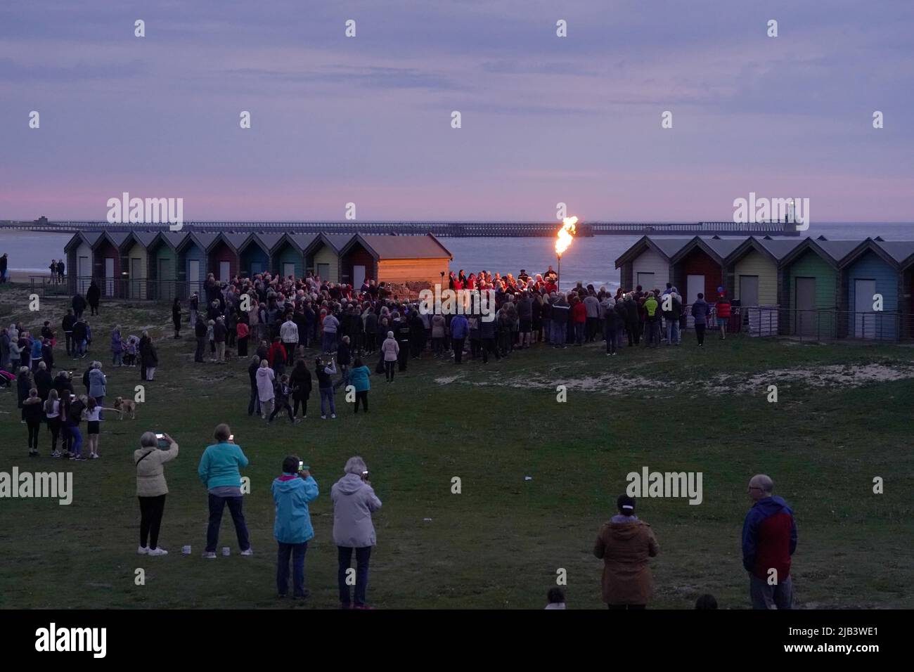 A Platinum Jubilee beacon is lit on Blyth beach, Northumberland, on day