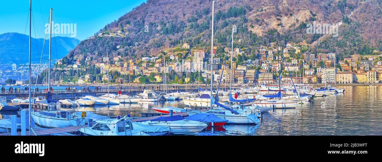 Panorama of yachts and boats on Lake Como against Monte Boletto with living houses and villas of Como, Lombardy, Italy Stock Photo