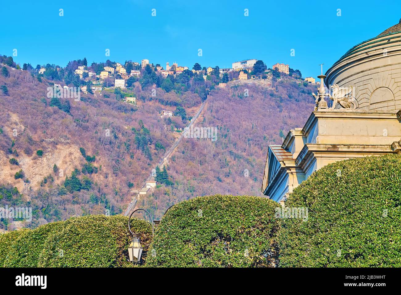 The slope of Monte Boletto with Como-Brunate funicular railway, housing of Brunate on the mountain top and the dome of Tempio Voltiano in the foregrou Stock Photo