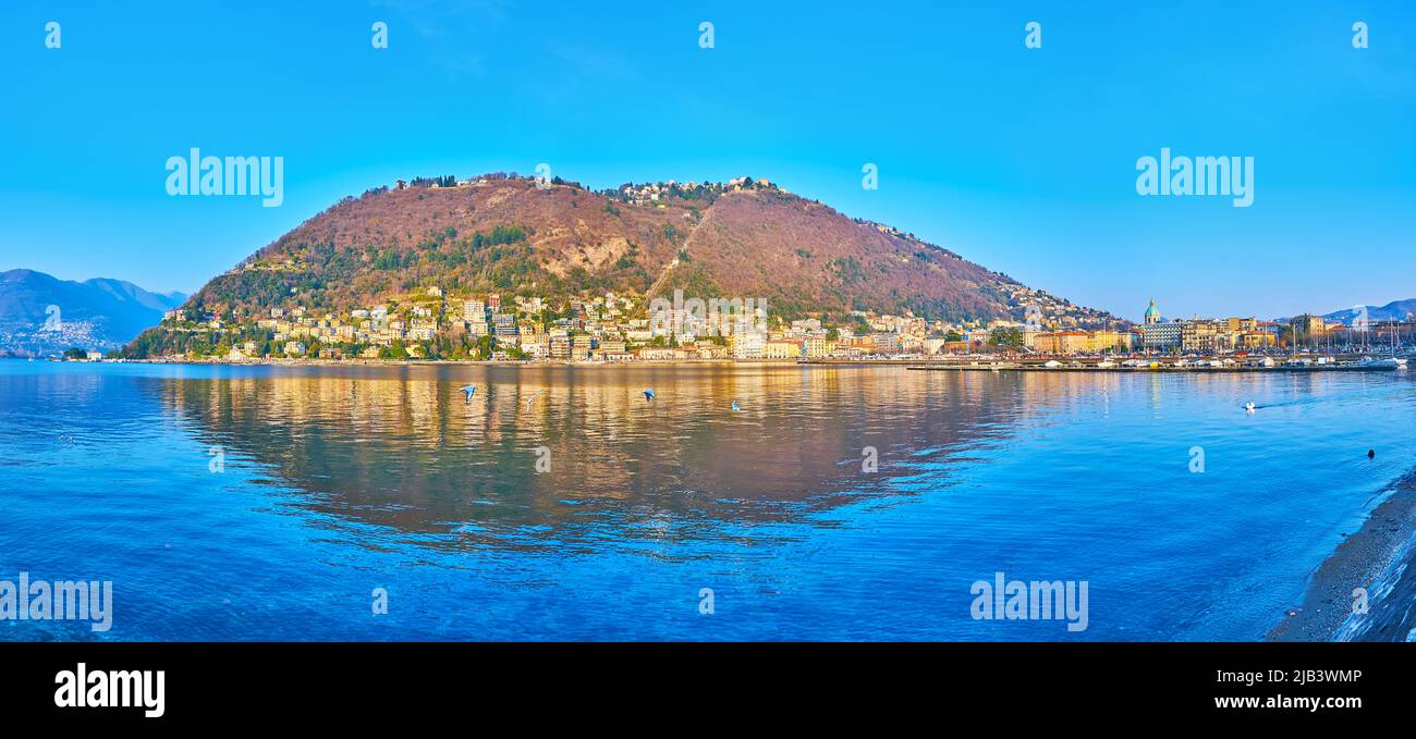 Enjoy the picturesque view of bright blue Lake Como and Monte Boletto, reflecting on lake surface, Como, Lombardy, Italy Stock Photo