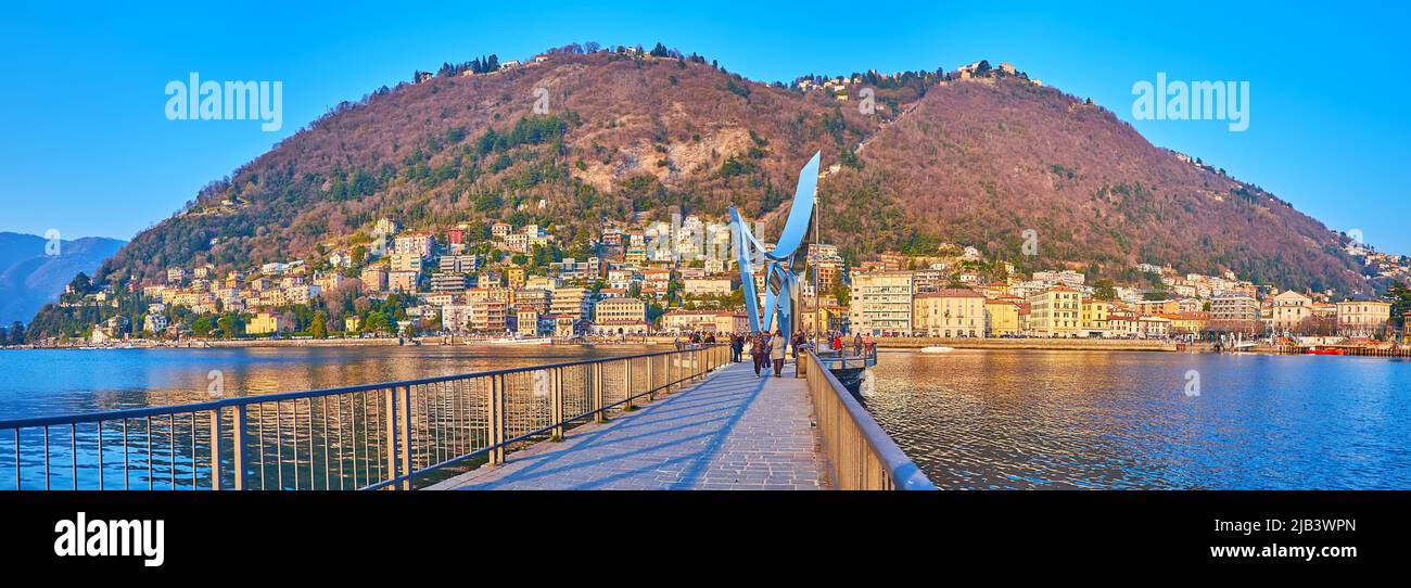 COMO, ITALY - MARCH 20, 2022: Panorama of Lake Como, Monte Boletto, Piero Foranea Caldirola Dam and Electric Life sculpture, on March 20 in Como Stock Photo