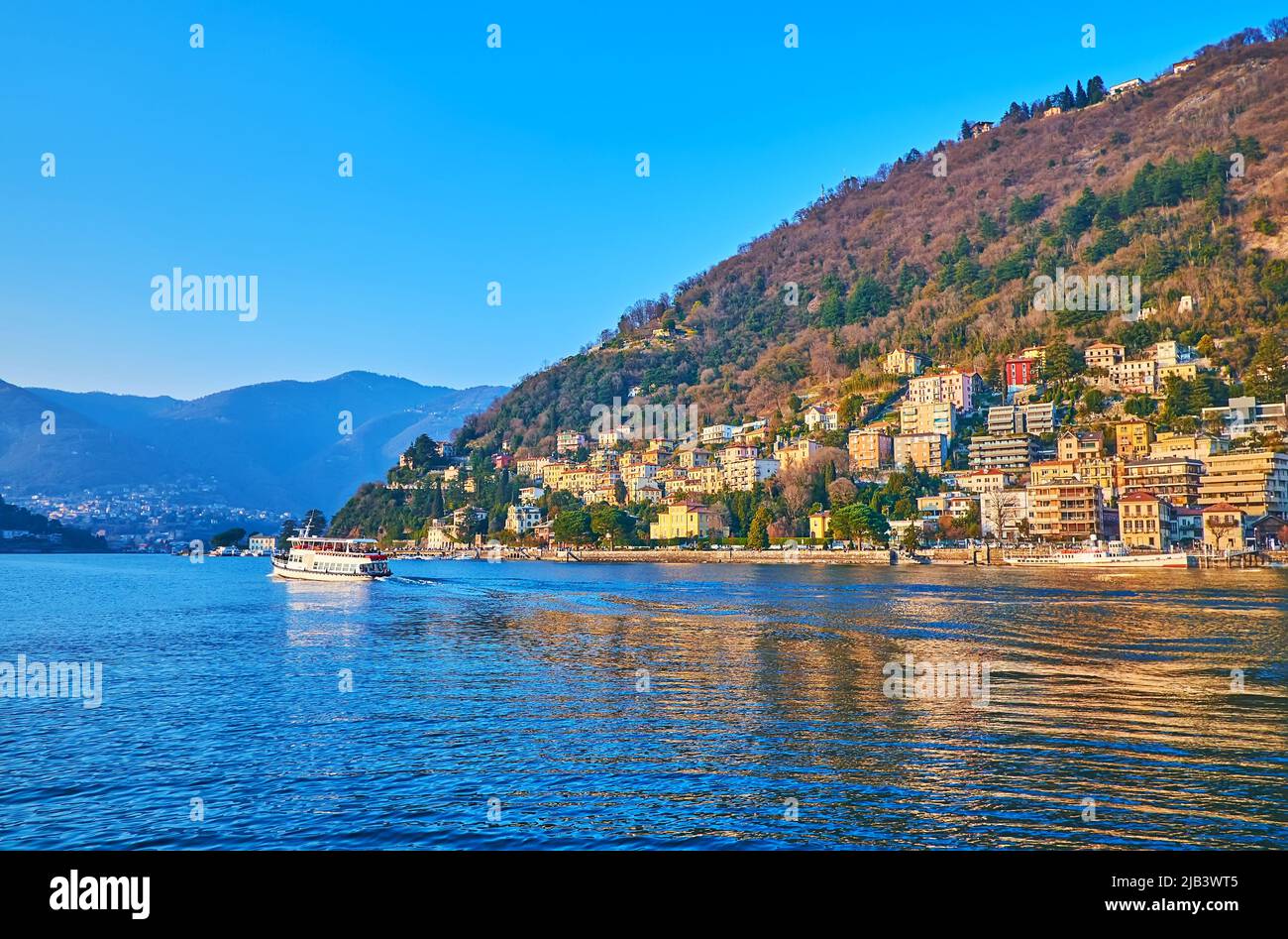 Enjoy the view of Lake Como with white ferry, floating along the Monte Boletto, Como, Italy Stock Photo