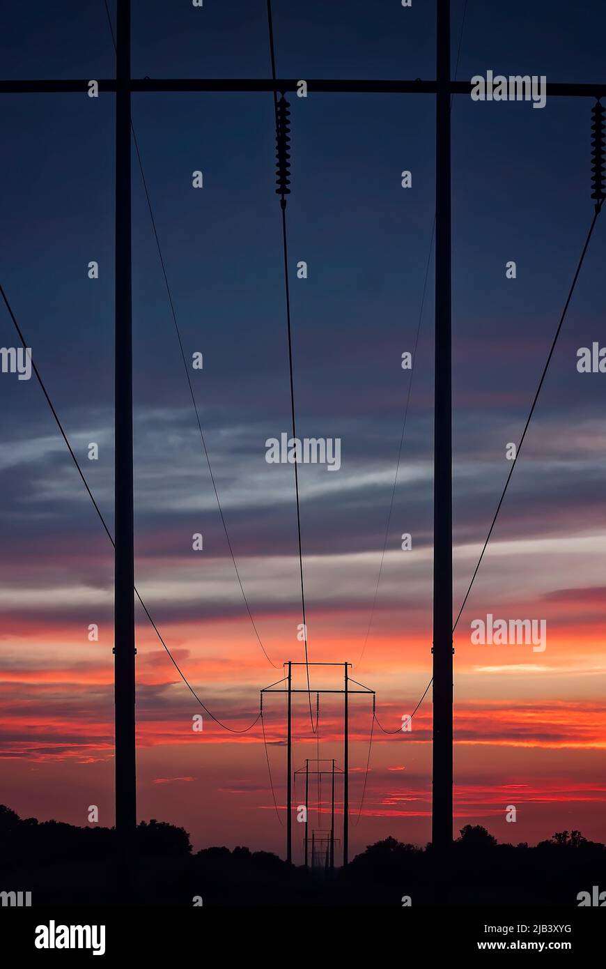 Wooden H-frame transmission line power poles are pictured at sunset, June 13, 2011, in Columbus, Mississippi. Stock Photo