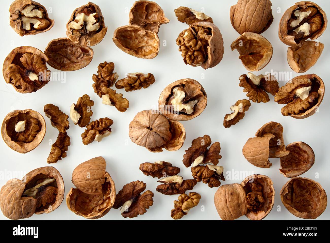 Chopped walnuts and shells on a white background Stock Photo Alamy