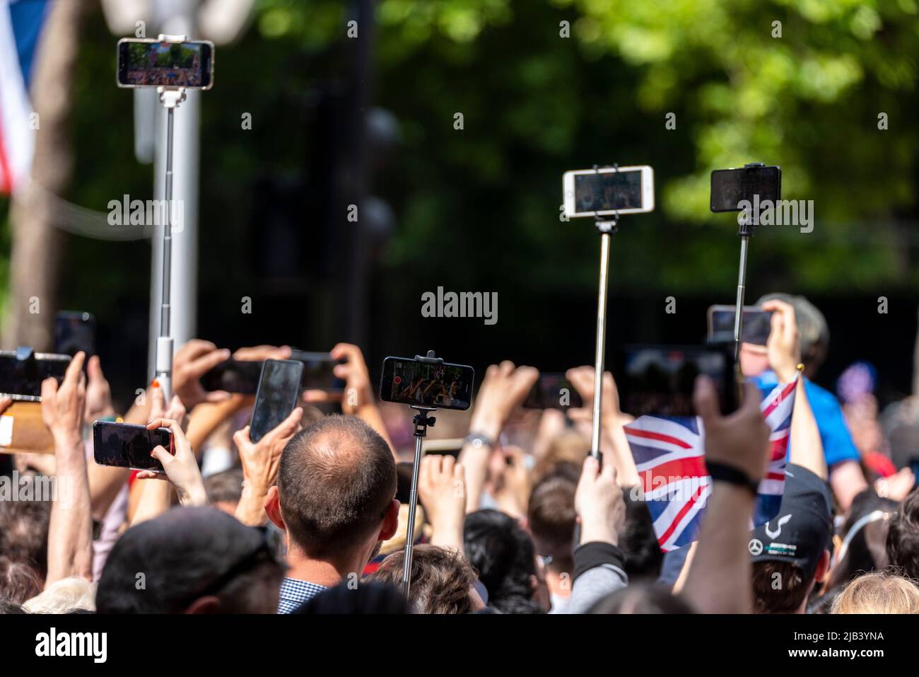 Crowd using mobile phone cameras raised to film and photograph the ...