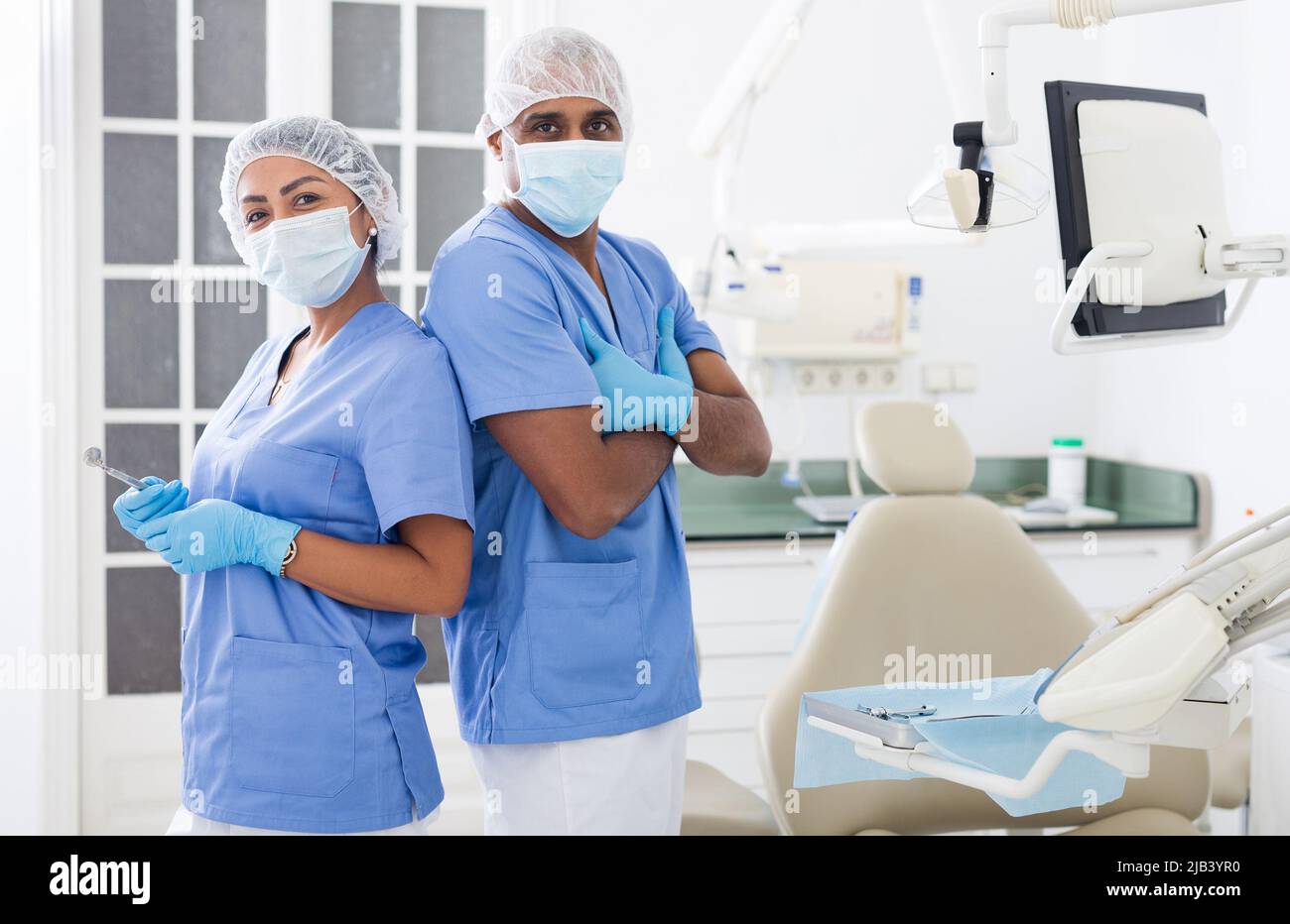 Two professional dentists standing in modern dental clinic Stock Photo