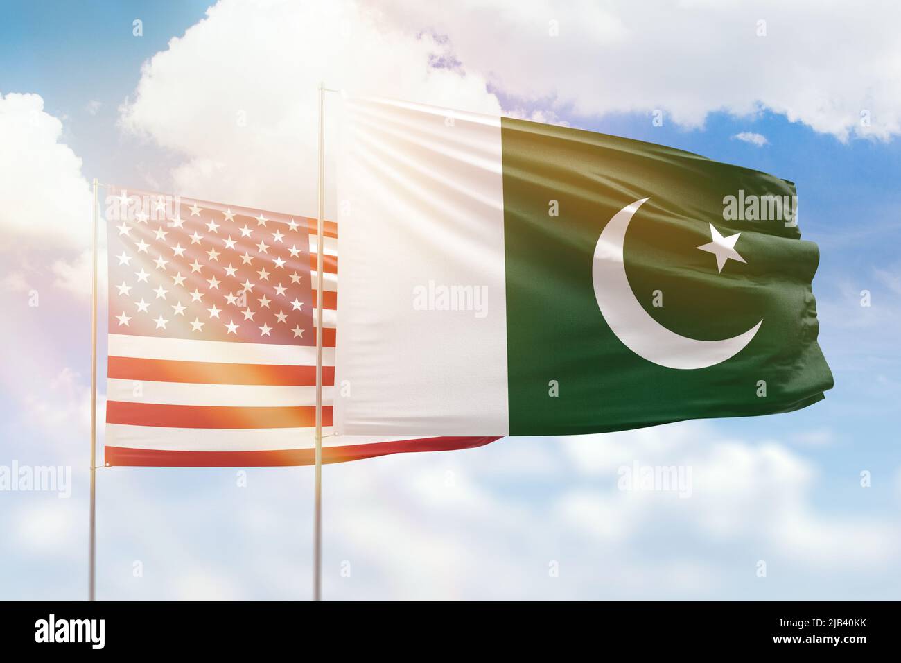 Sunny blue sky and flags of pakistan and usa Stock Photo