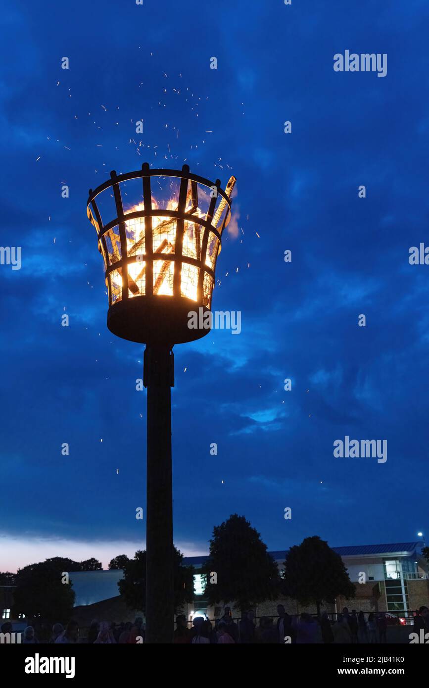 Queen Elizabeth Platinum 70th Jubilee beacon lit, burning against the night sky at dusk, Newmarket Suffolk UK 2nd June 2022 Stock Photo