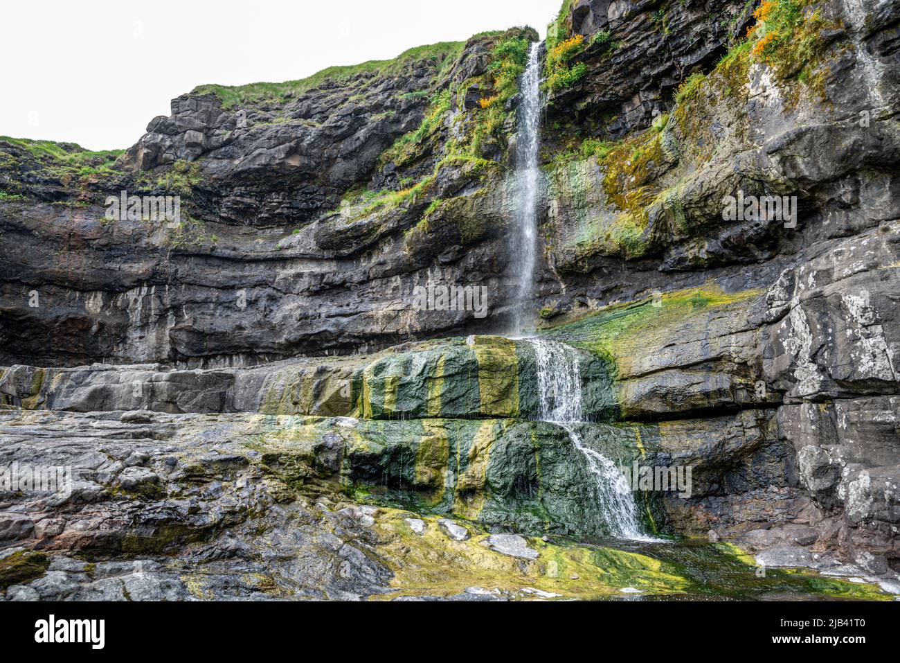 Small waterfall on Mikladalur cliffs, Kalsoy Island, Faroe Islands Stock Photo