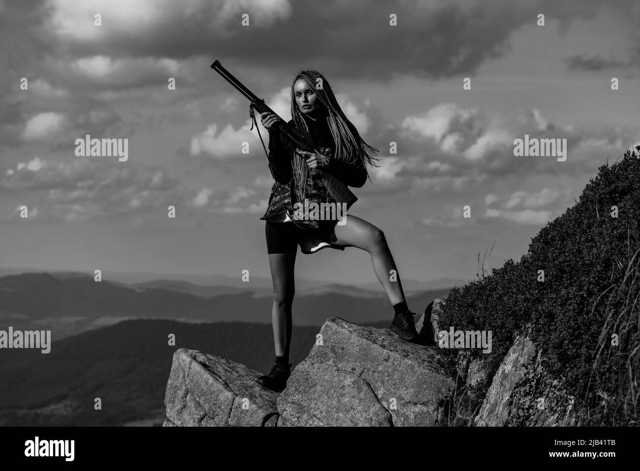 Hunter girl. Hunting in America. Young hunter woman holding gun and
