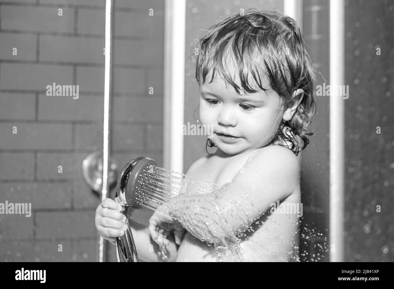 Kid having fun to bath. Little baby taking bath, closeup face portrait of smiling boy, health