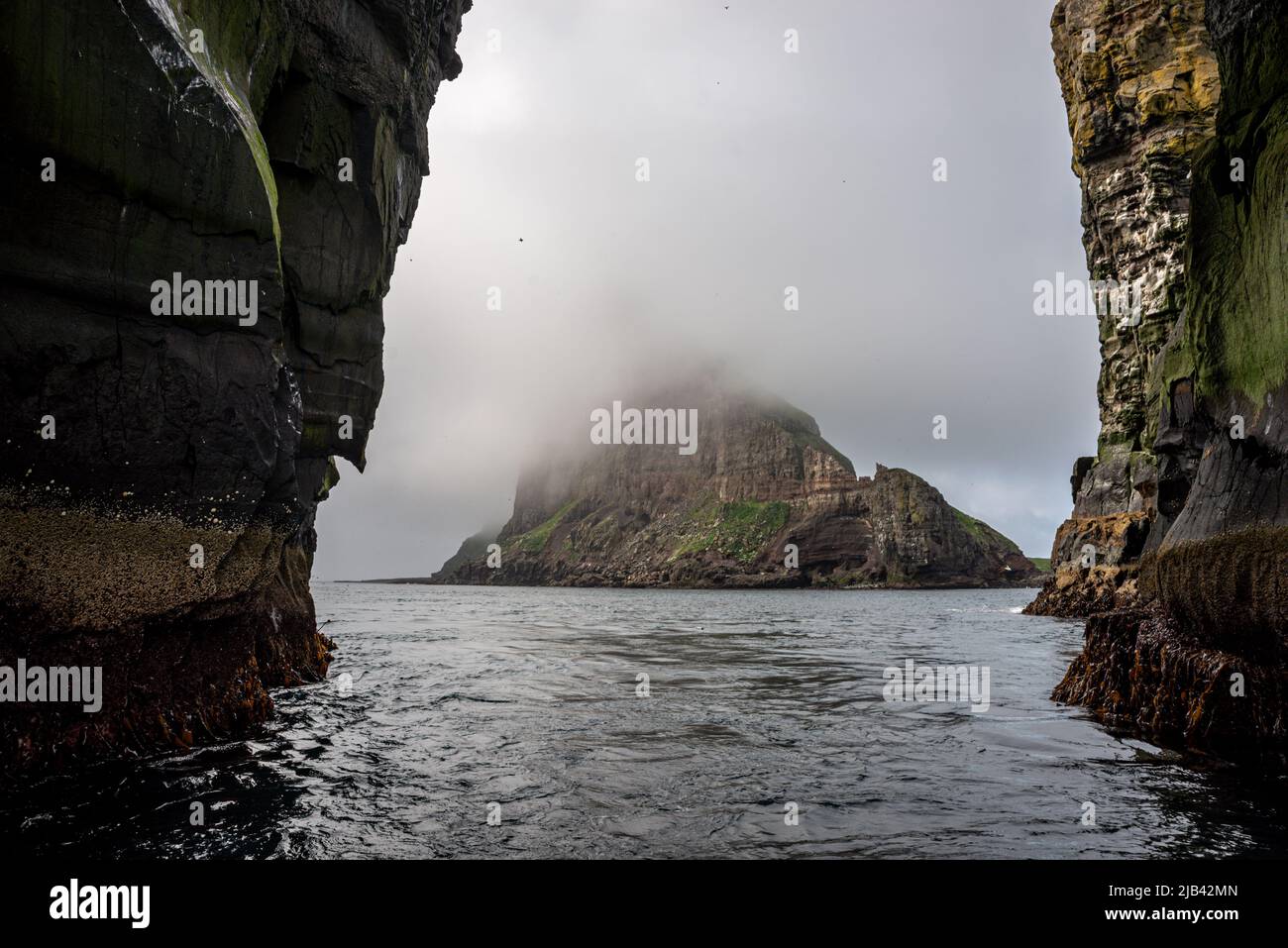 Tindhólmur islet seen through the arch of Stori Drangur of Drangarnir