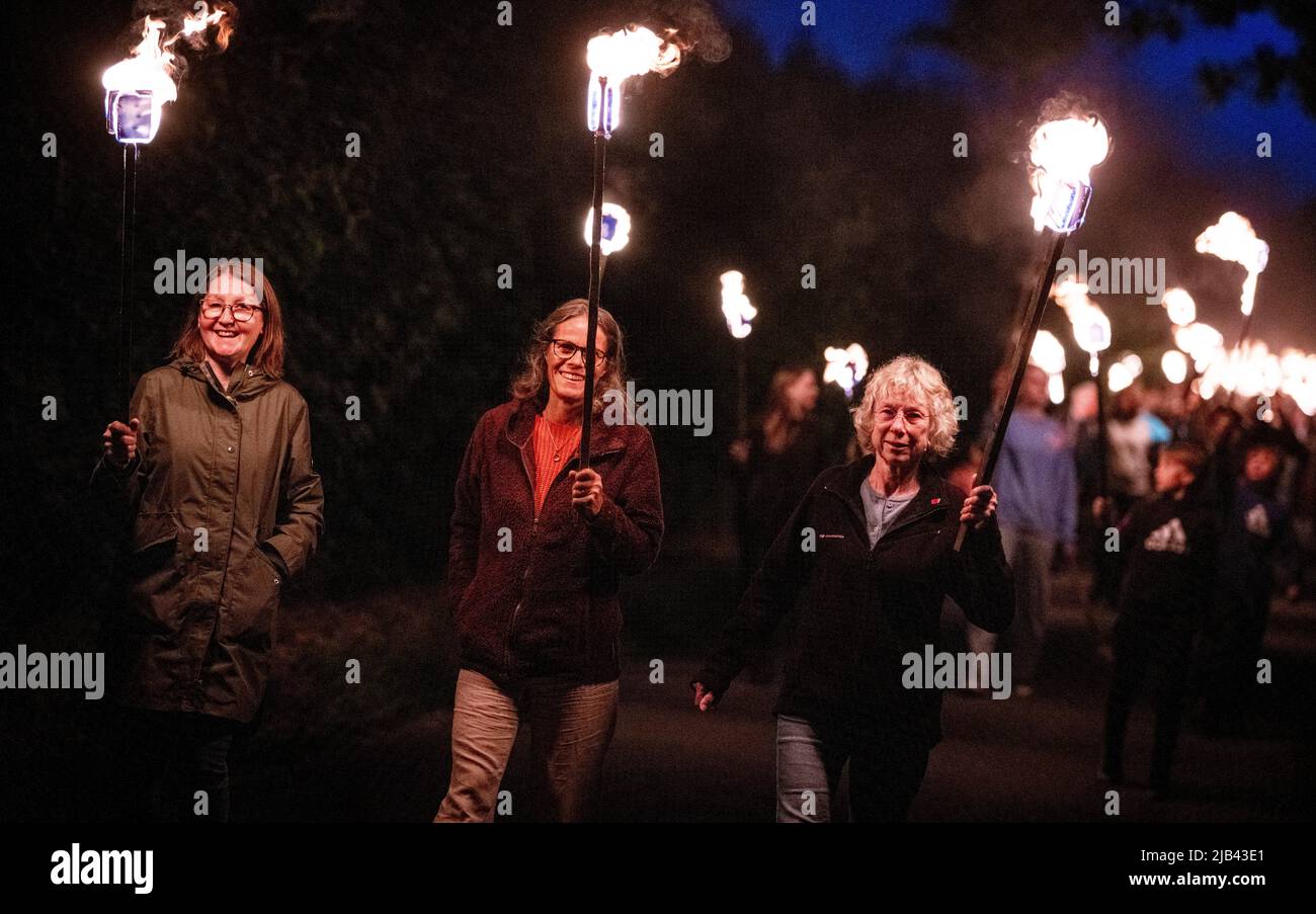 East Hoathly, UK. 2nd June, 2022. Residents of the village of East Hoathly in East Sussex light a beacon as part of the Queen's Platinum Jubilee celebrations. Followed by a torchlit procession through the country lanes back to the village centre. Credit: Jim Holden/Alamy Live News Stock Photo