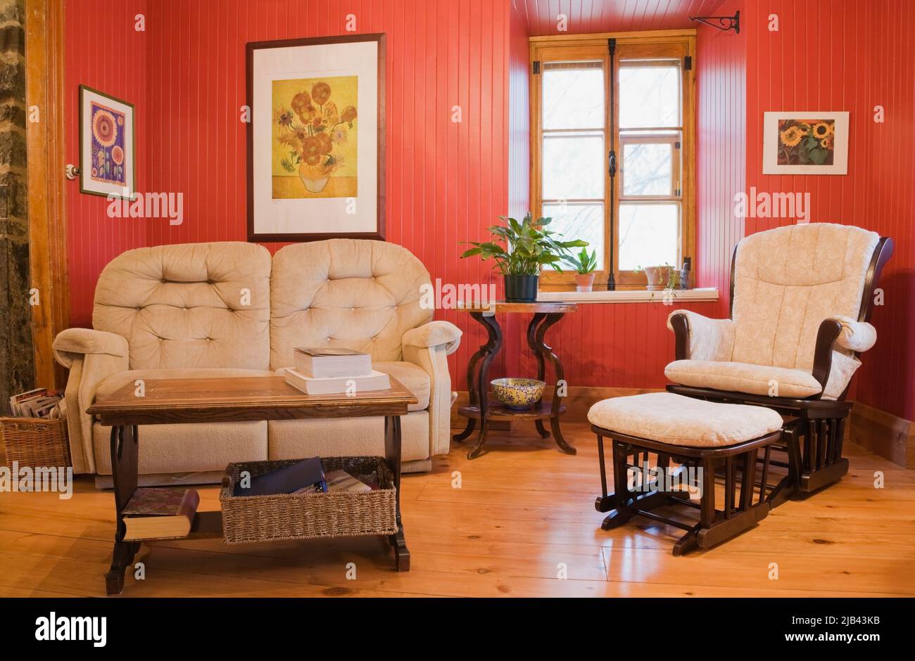 Beige upholstered reclining sofa and armchair with ottoman in parlour room inside old circa 1832 ...