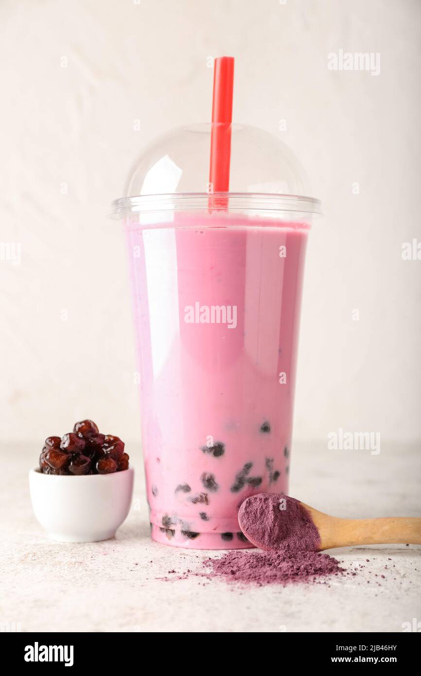 Plastic cup of tasty bubble tea on light table Stock Photo Alamy