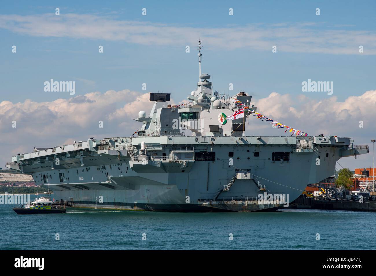 HMS Queen Elizabeth dressed overall for the Queen's Platinum Jubilee. Seen alongside at Portsmouth Naval Base, UK on Coronation Day the 2nd June 2022. Stock Photo