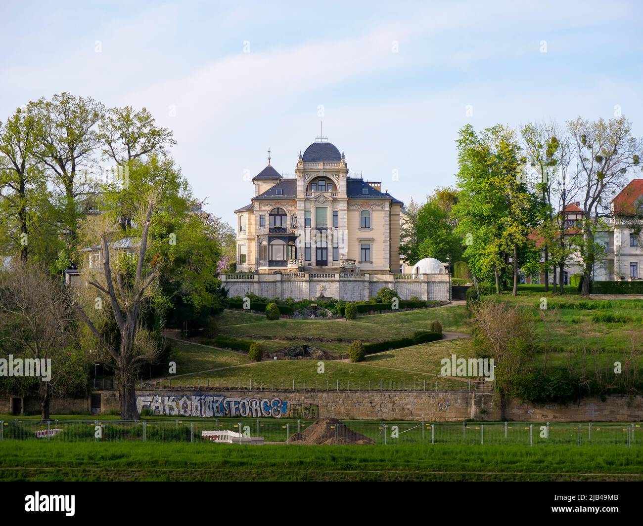 Old villa building in the elbe valley. Luxury real estate with a big garden. Green trees are