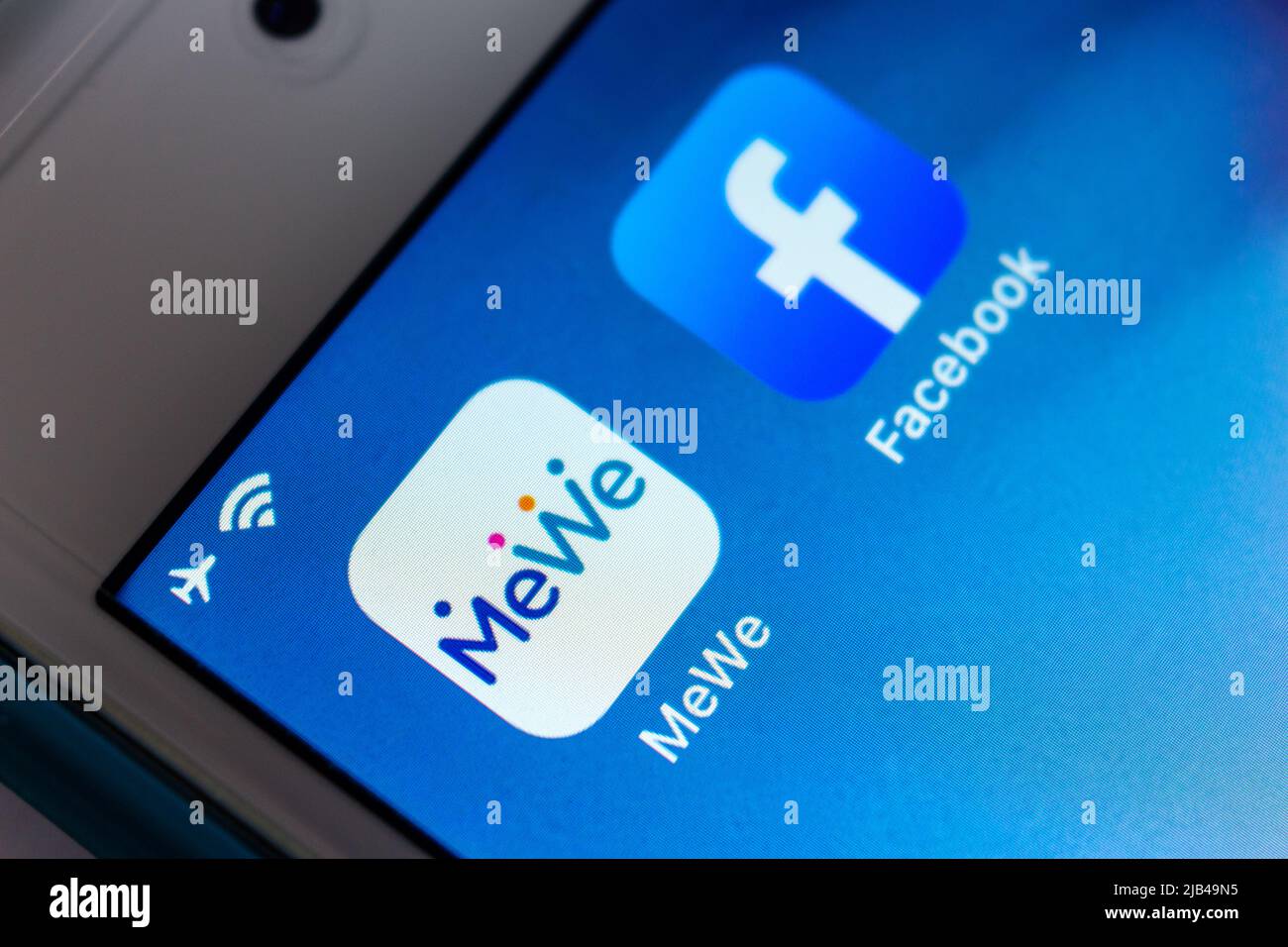 MeWe & Facebook on iPhone. MeWe is US alt-tech sns owned by Sgrouple. Due to MeWe focuses on data privacy, it described itself as anti-Facebook Stock Photo