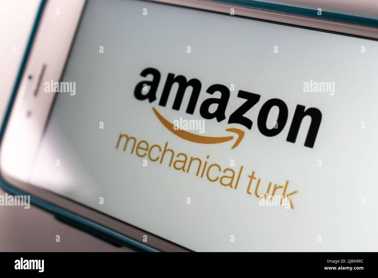 Logo of Amazon Mechanical Turk (MTurk), crowdsourcing website to hire crowdworkers for on-demand tasks that computers are unable to do, on iPhone Stock Photo