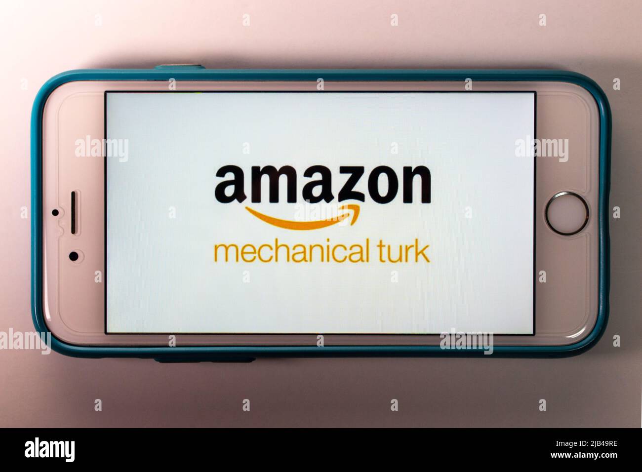 Logo of Amazon Mechanical Turk (MTurk), crowdsourcing website to hire crowdworkers for on-demand tasks that computers are unable to do, on iPhone Stock Photo