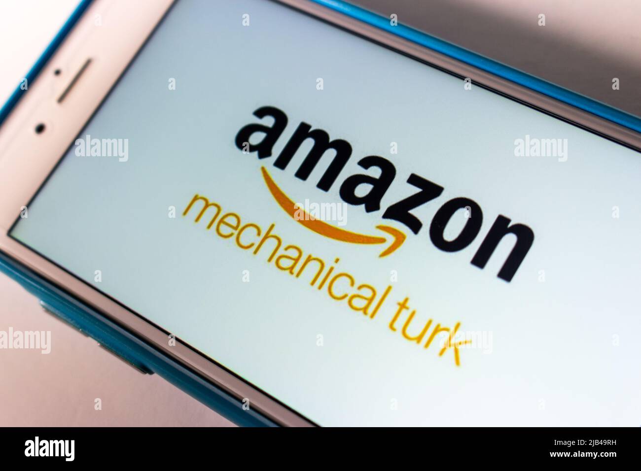 Logo of Amazon Mechanical Turk (MTurk), crowdsourcing website to hire crowdworkers for on-demand tasks that computers are unable to do, on iPhone Stock Photo