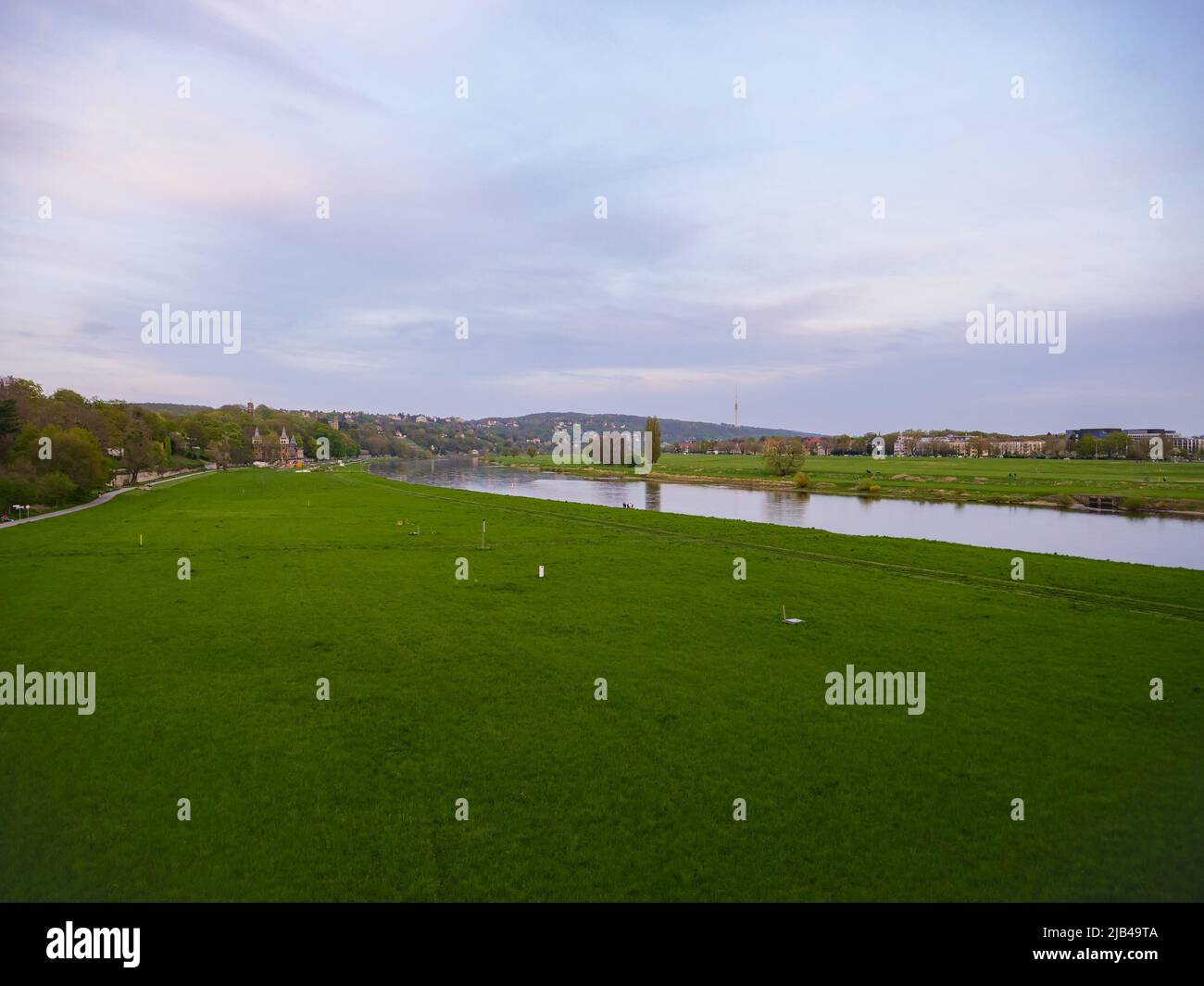 Large riverbanks of the Elbe river in Dresden. Green meadows in the Elbe valley. There is a lot of space for the river and the water. Stock Photo