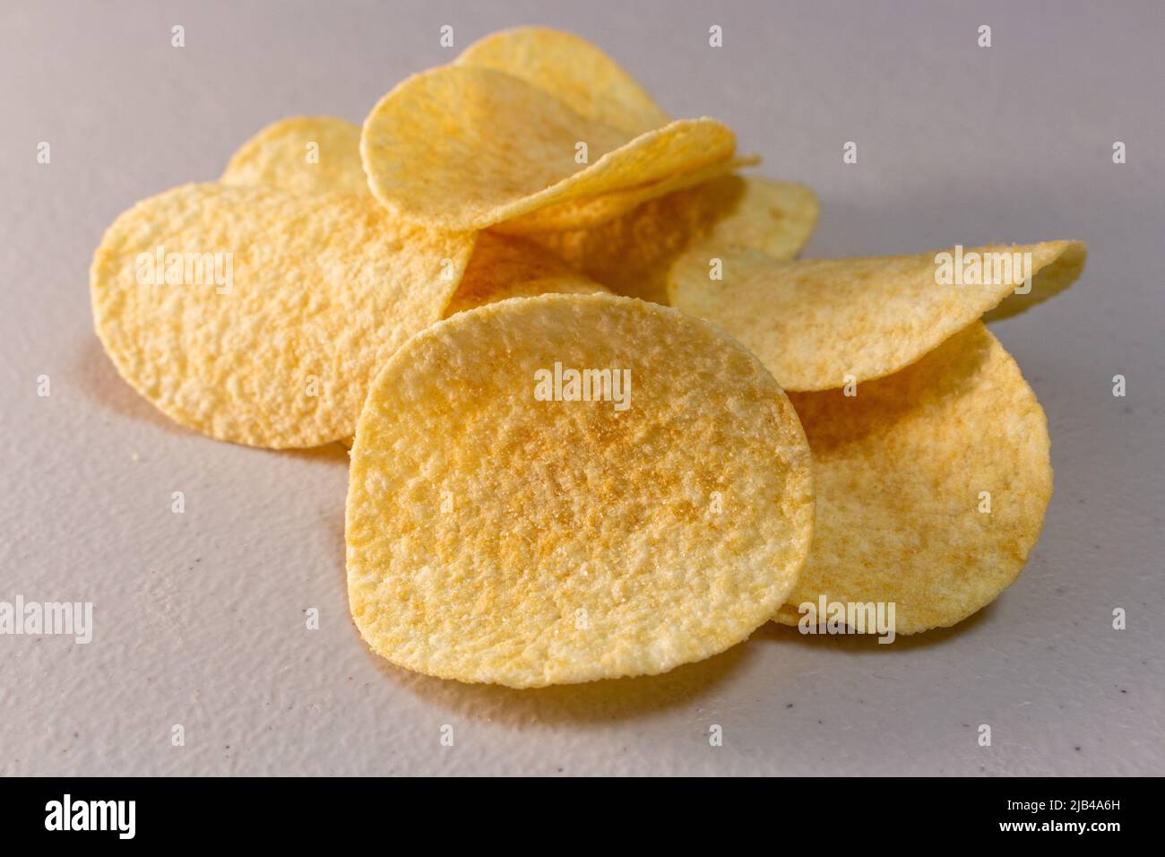 Plain Potato Chips (Crisps) on white table Stock Photo Alamy