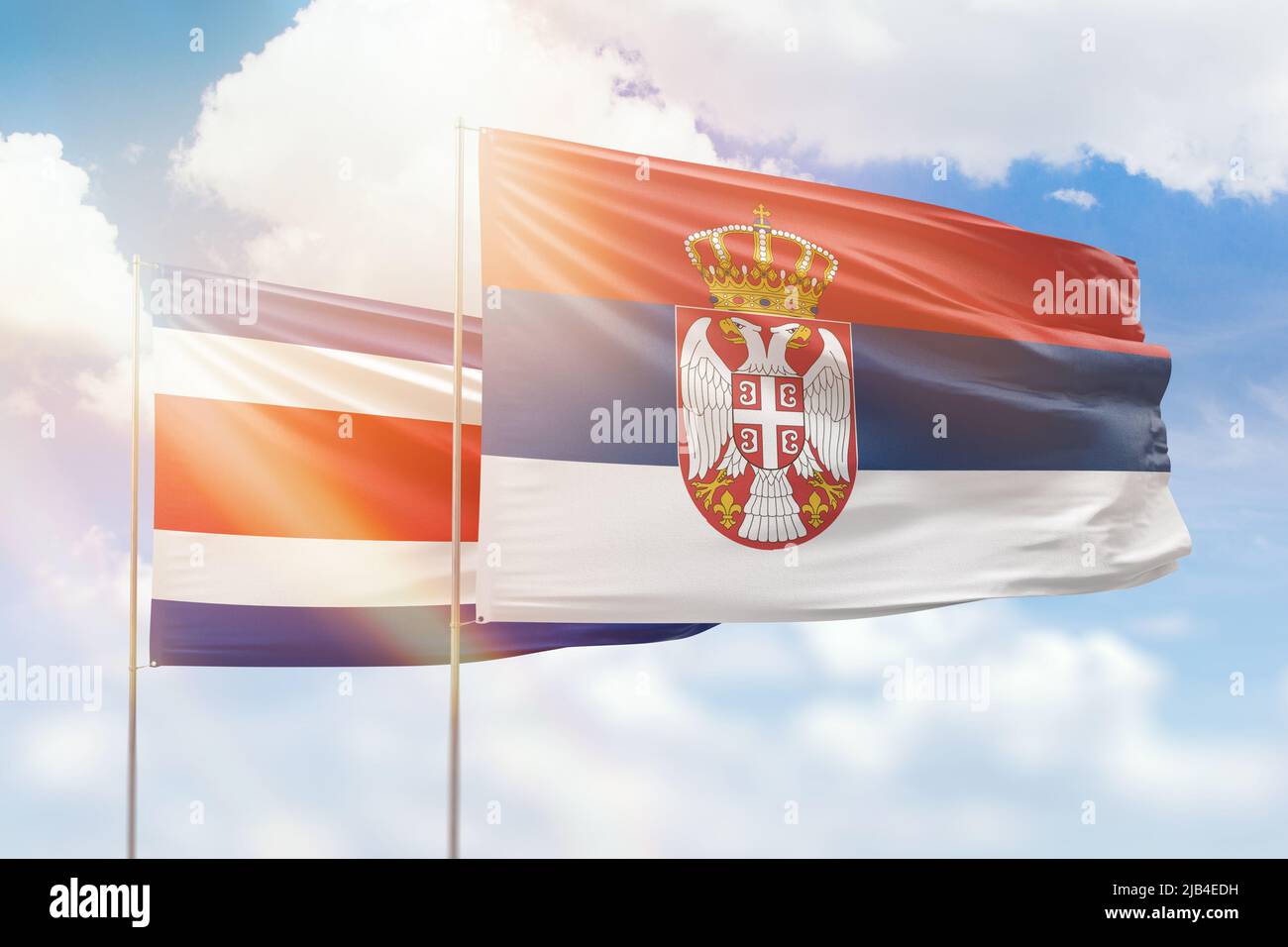 Sunny Blue Sky And Flags Of Serbia And Costa Rica Stock Photo Alamy