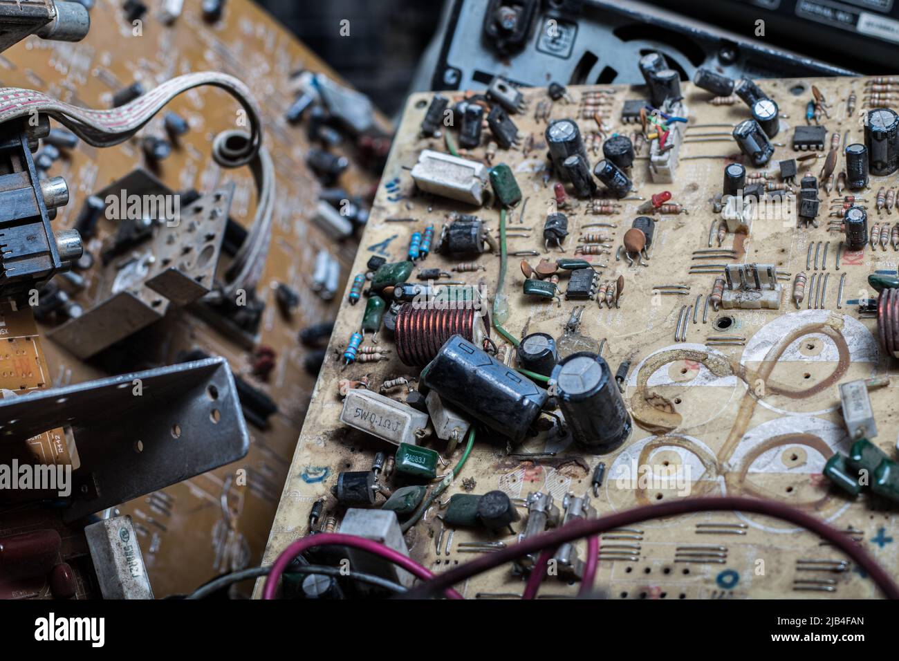A broken circuit board is seen amidst other electronic wastes at an e