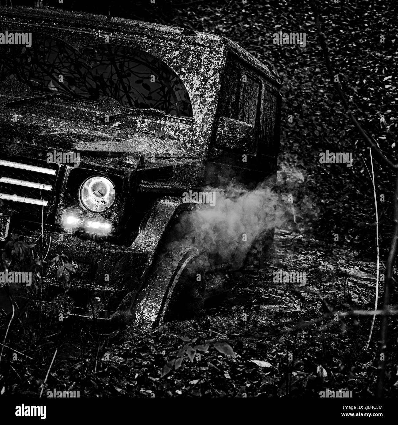 Offroad vehicle coming out of a mud hole hazard. Road adventure