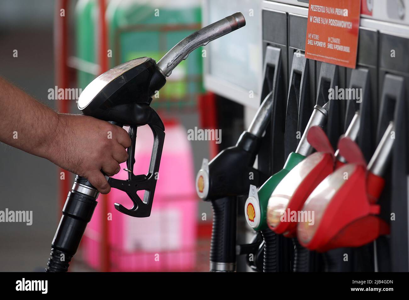Shell gas station worker uses fuel distributor. (Photo by Vito Corleone ...