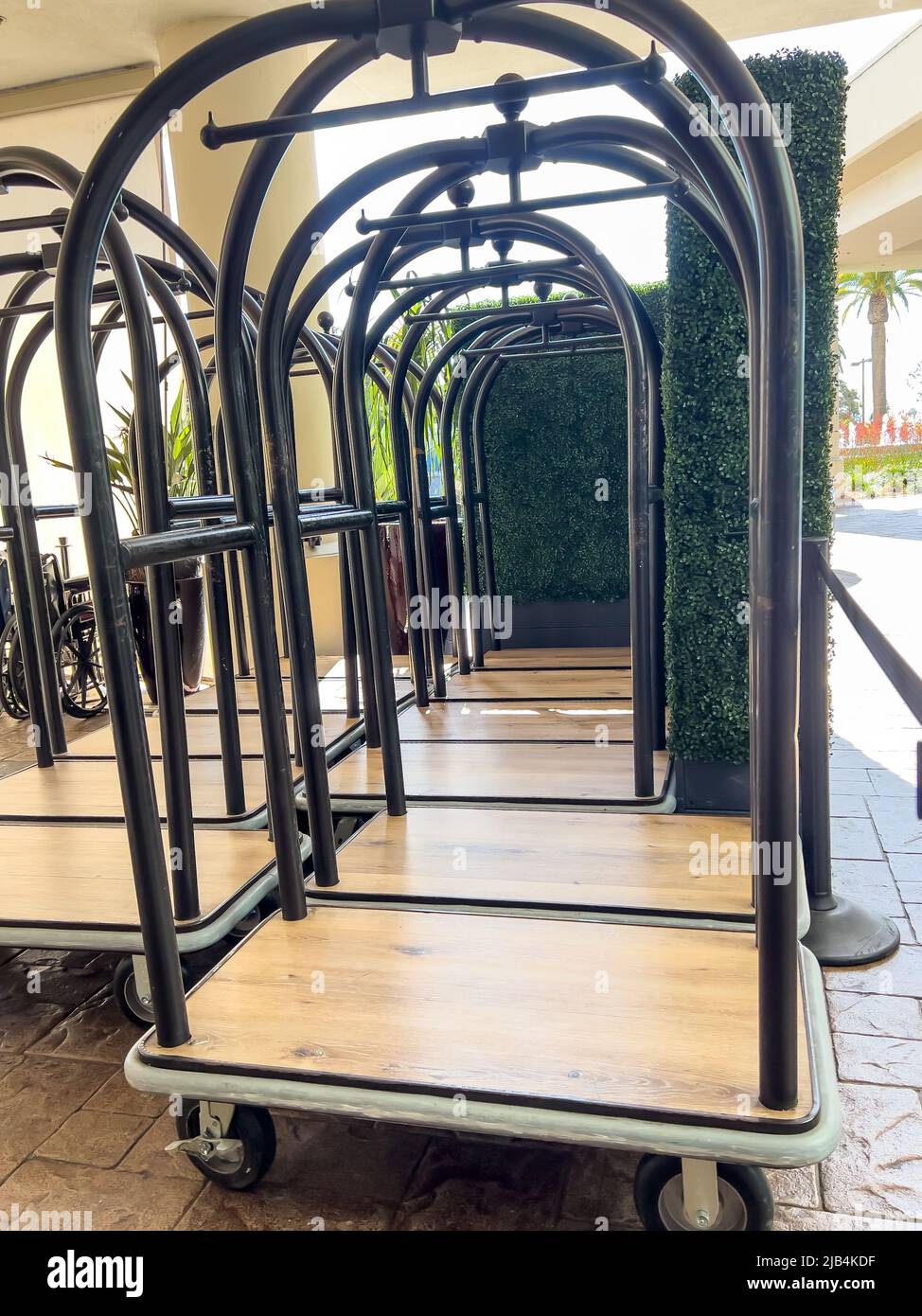 Group of hotel luggage carts at the entrance for guests checking in. Stock Photo