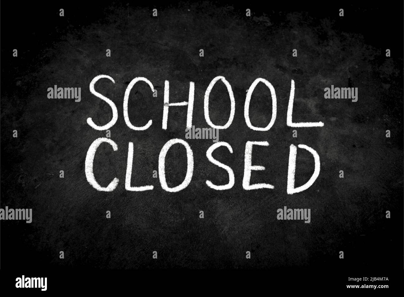 Close up phrase "School Closed" by handwriting white coloured chalk on