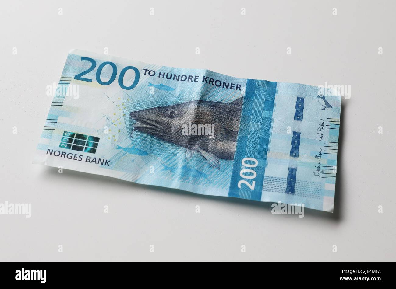 Trondheim, Norway - May 26, 2022: High angle view of a 2017 edition 200 krona used Norwegian banknote on a grey surface. Stock Photo