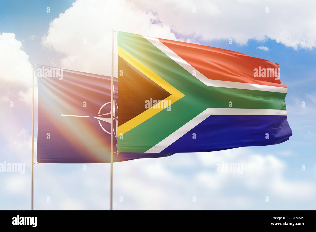 Sunny blue sky and flags of south africa and nato Stock Photo Alamy