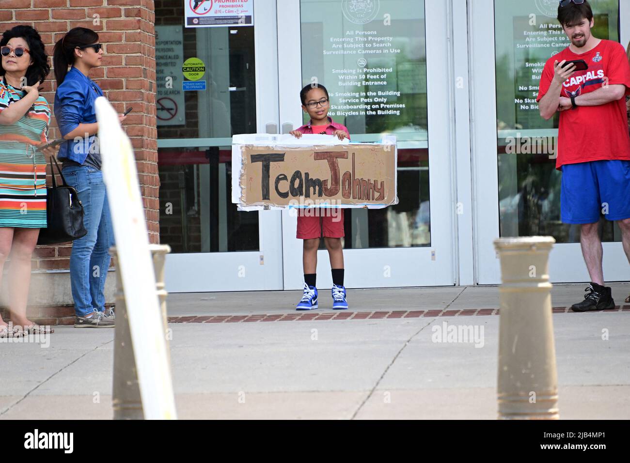 A young fan carries a sign outside the Fairfax County Courthouse, in Fairfax, Virginia as the jury verdict is awaited on Wednesday, June 1, 2022. Johnny Depp Depp brought a defamation lawsuit against his former wife, actress Amber Heard, after she wrote an op-ed in The Washington Post in 2018 that, without naming Depp, accused him of domestic abuse. Photo by Ron Sachs/CNP/ABACAPRESS.COM Stock Photo