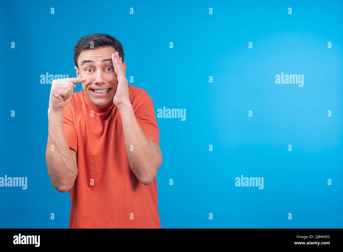 Ashamed man covering face and pointing away Stock Photo