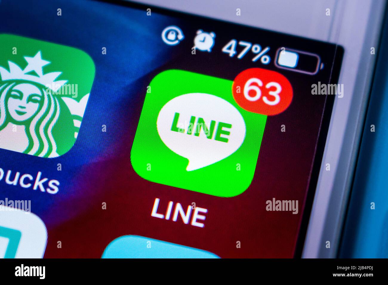 Kumamoto, Japan - Apr 29, 2020 : LINE app with badge 63 on iPhone home screen. LINE is a freeware app for instant communications on electronic devices Stock Photo