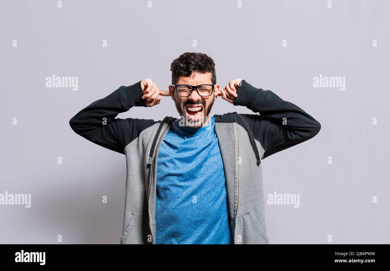 Irritated person screaming covering his ears, desperate person avoiding
