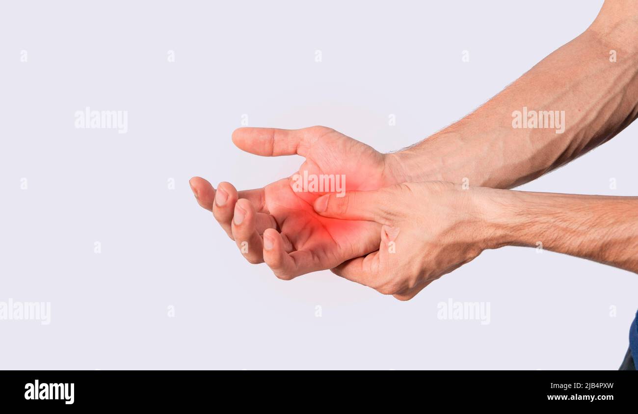Person with palm pain, concept of a man with pain in the hands, man with arthritis rubbing, person with pain in the hands Stock Photo