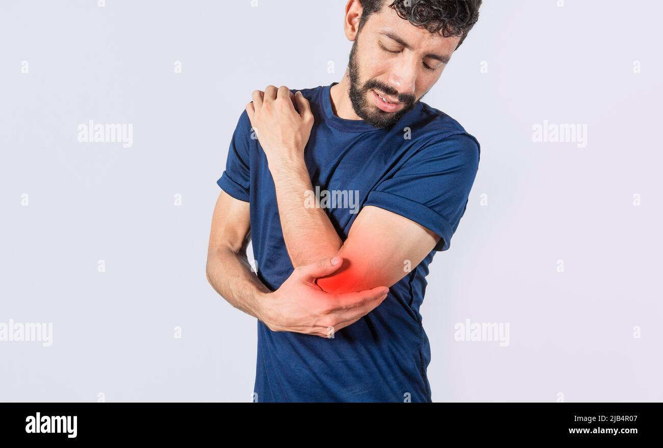Person with elbow pain, concept of a man with rheumatism elbow pain, man massaging sore elbow, man with elbow cramp Stock Photo
