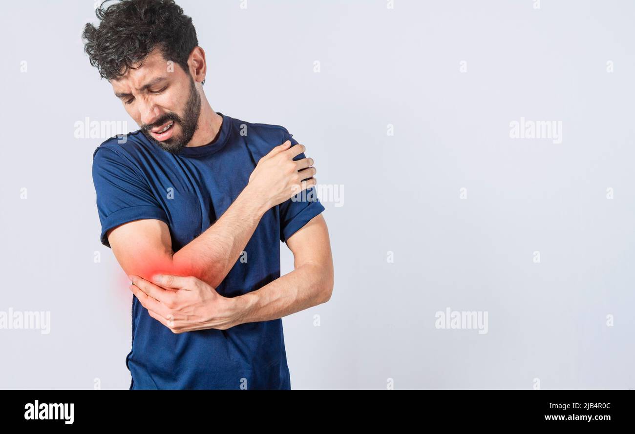 Person with elbow pain, concept of a man with rheumatism elbow pain, man massaging sore elbow, man with elbow cramp Stock Photo