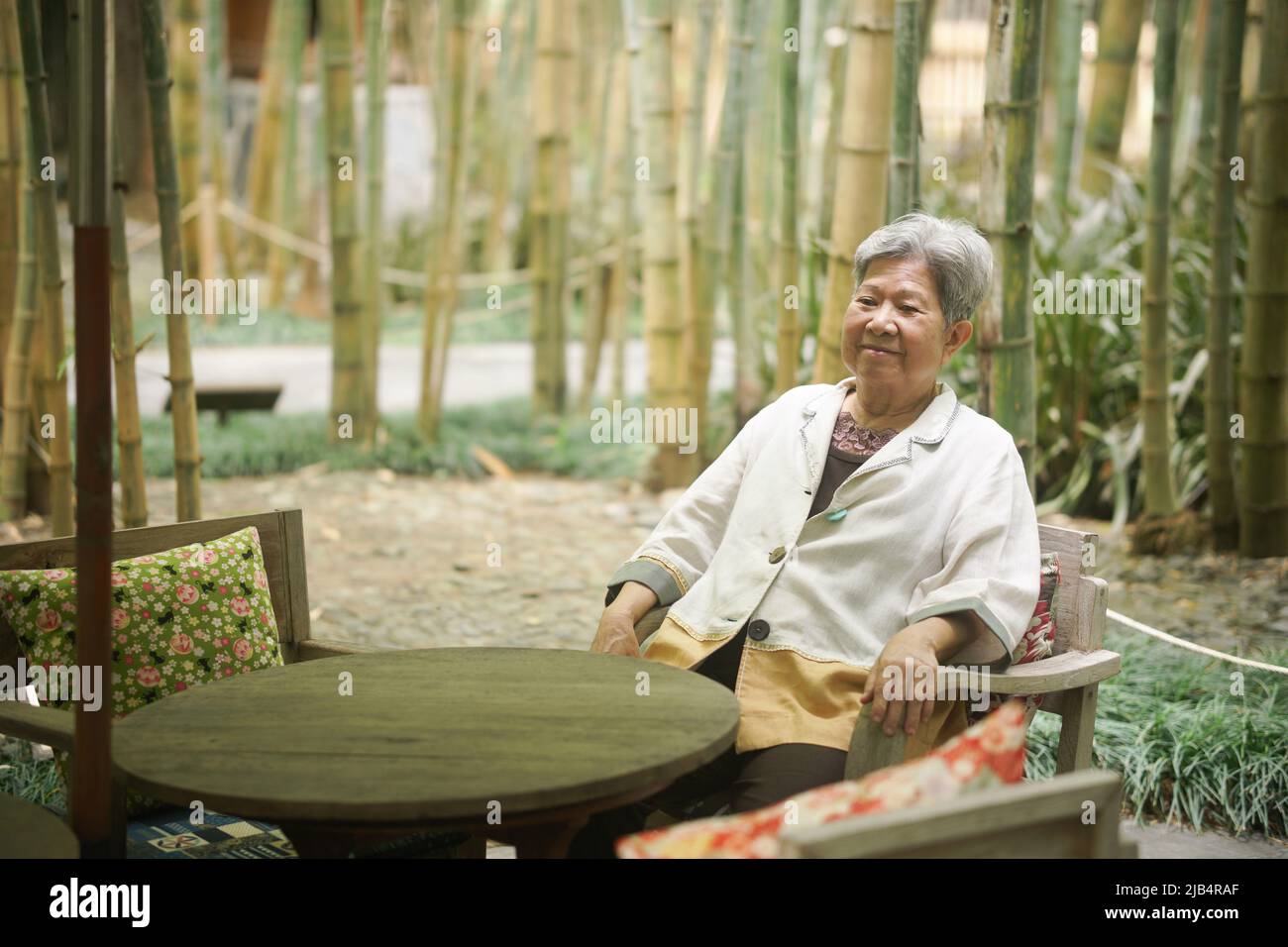 old elderly senior elder woman relaxing on terrace. mature retirement lifestyle Stock Photo